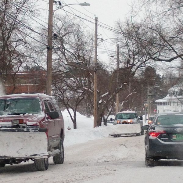 Photo of a snowplow on a snowy road. 