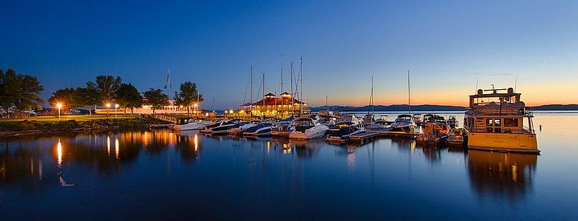 Photo of the Burlington Harbor at night.